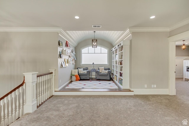 unfurnished room with lofted ceiling, ornamental molding, and carpet