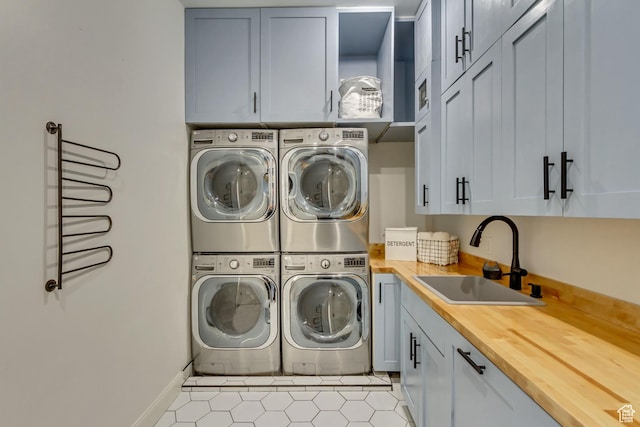 laundry area with cabinets, sink, stacked washer / drying machine, and independent washer and dryer