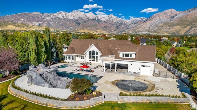 rear view of house with a mountain view and a patio area