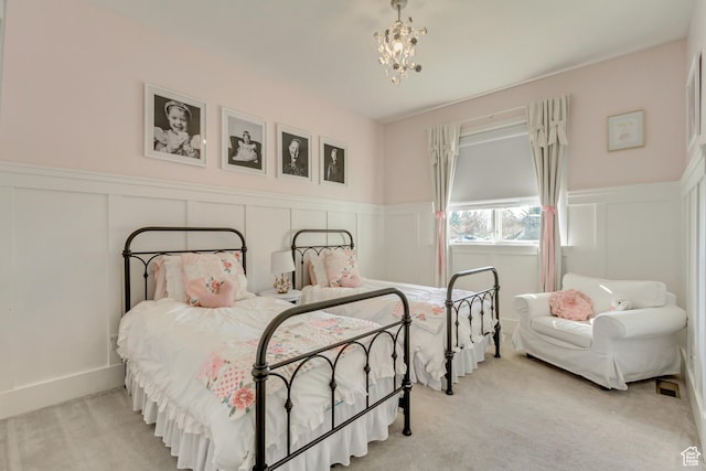 bedroom with a chandelier and light carpet