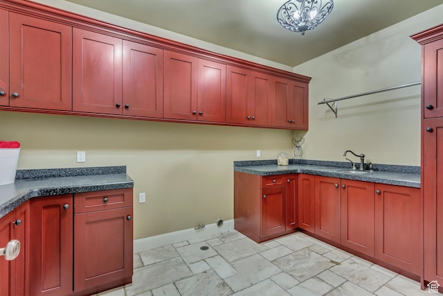 laundry area with cabinets and sink