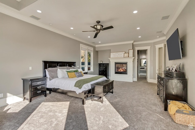 carpeted bedroom with ceiling fan and ornamental molding