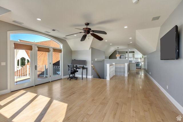 interior space featuring lofted ceiling, ceiling fan, and light hardwood / wood-style flooring