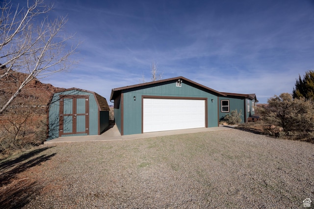 view of front of property featuring a garage and a shed