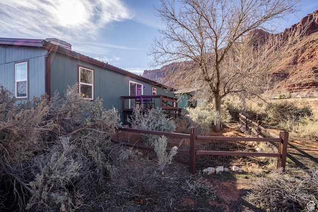 view of property exterior with a deck