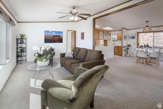 living room with crown molding, lofted ceiling, light carpet, and ceiling fan