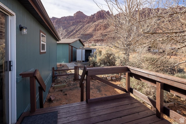 wooden deck featuring a mountain view