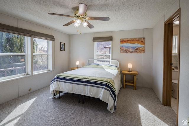 bedroom with ceiling fan and a textured ceiling