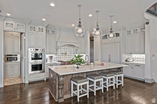 9632 N 5650 W, Highland, UT 84003 - kitchen with dark wood-type flooring, hanging light fixtures, an island with sink, custom range hood, and stainless steel double oven