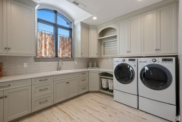 9632 N 5650 W, Highland, UT 84003 - washroom with cabinets, washing machine and dryer, sink, and light hardwood / wood-style flooring