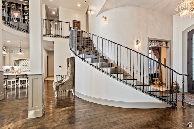 9632 N 5650 W, Highland, UT 84003 - stairs featuring hardwood / wood-style flooring, a towering ceiling, a chandelier, and sink