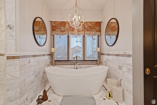 9632 N 5650 W, Highland, UT 84003 - bathroom with an inviting chandelier, a bathtub, and tile walls