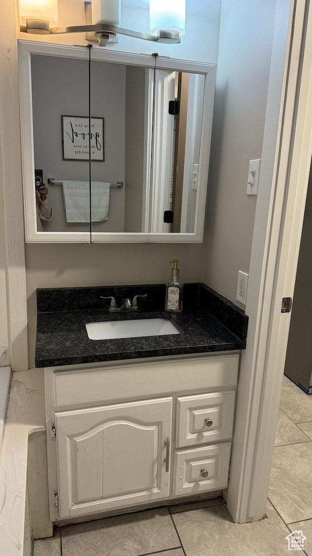 bathroom with vanity and tile patterned flooring