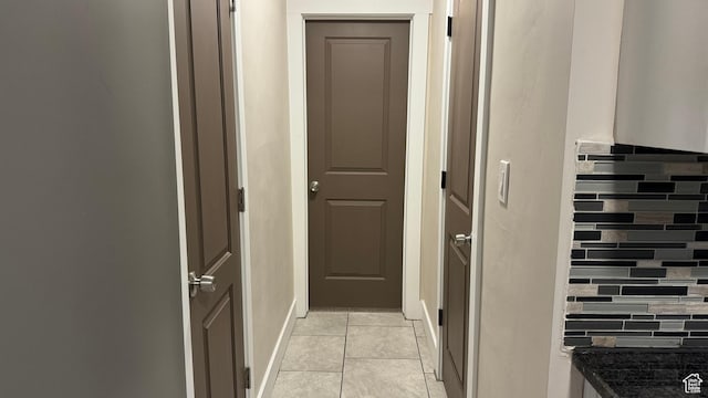 hall with light tile patterned floors