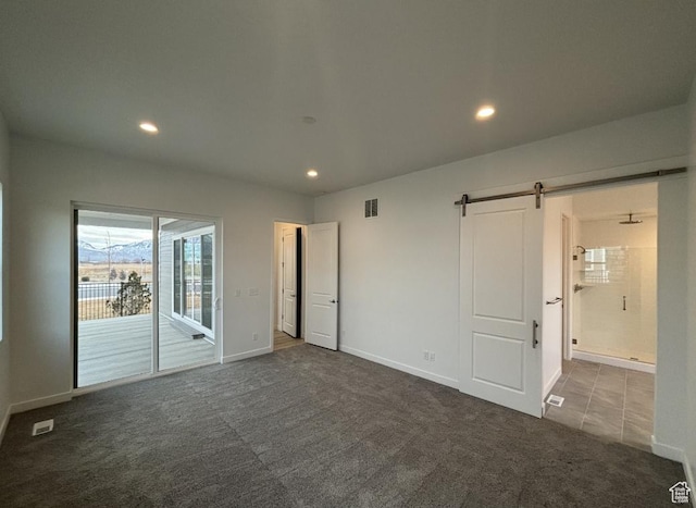 284 E Polaris Dr Unit 112, Saratoga Springs, UT 84045 - unfurnished bedroom featuring dark colored carpet, a barn door, access to outside, and ensuite bathroom