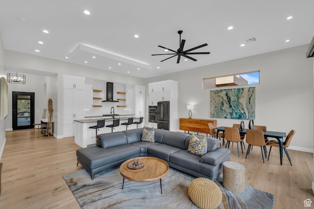 2090 N Tuweap Dr Unit 56, St George, UT 84770 - living room featuring sink, ceiling fan with notable chandelier, and light wood-type flooring