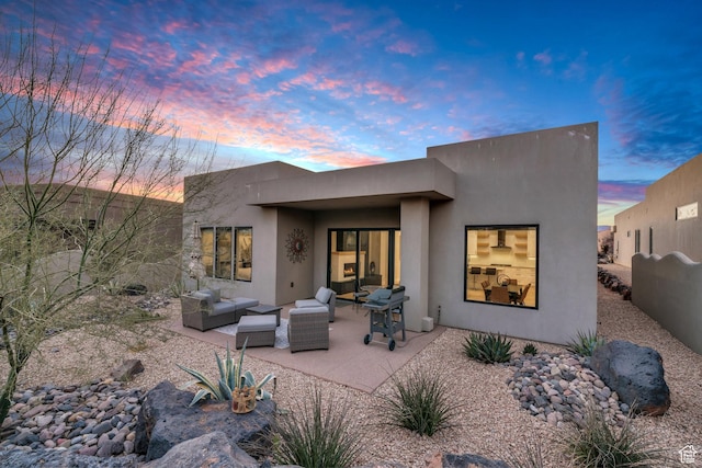 2090 N Tuweap Dr Unit 56, St George, UT 84770 - rear view of property featuring stucco siding, a patio area, and outdoor lounge area