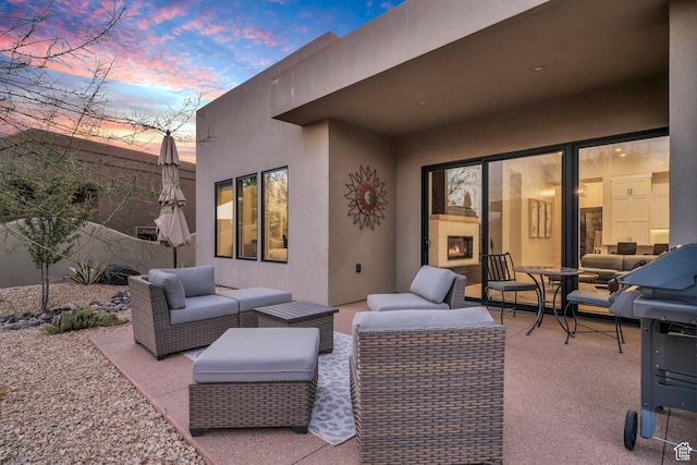 2090 N Tuweap Dr Unit 56, St George, UT 84770 - patio terrace at dusk with an outdoor living space with a fireplace and a patio area