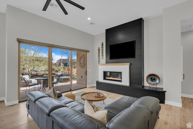 2090 N Tuweap Dr Unit 56, St George, UT 84770 - living room featuring a large fireplace, ceiling fan, and light hardwood / wood-style flooring