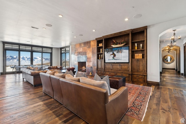 8435 N Ranch Garden Rd, Park City, UT 84098 - living room with arched walkways, dark wood-type flooring, recessed lighting, and a fireplace