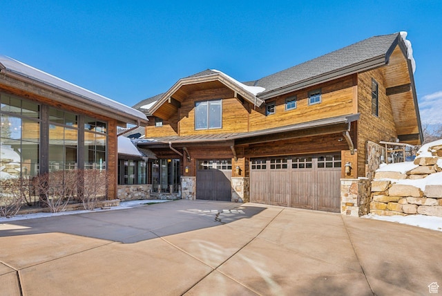 8435 N Ranch Garden Rd, Park City, UT 84098 - view of front of house featuring a garage, a standing seam roof, driveway, stone siding, and metal roof