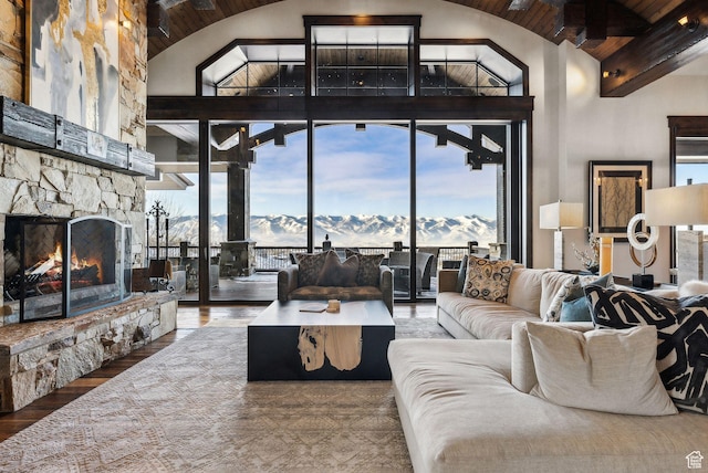 8435 N Ranch Garden Rd, Park City, UT 84098 - living room with plenty of natural light, high vaulted ceiling, a mountain view, a stone fireplace, and wood finished floors