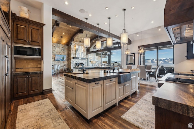 8435 N Ranch Garden Rd, Park City, UT 84098 - kitchen featuring a sink, black microwave, a center island with sink, dark wood-style flooring, and wooden ceiling