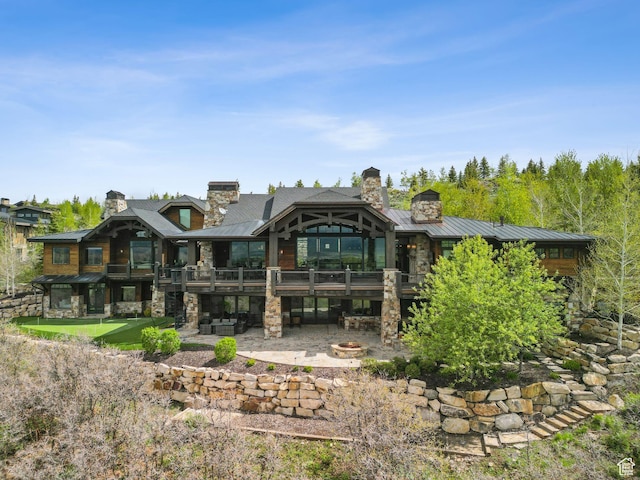 8435 N Ranch Garden Rd, Park City, UT 84098 - back of house with a standing seam roof, stone siding, a patio, and a deck