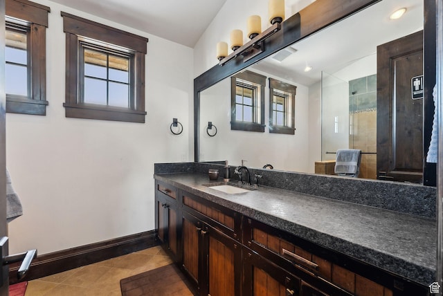 8435 N Ranch Garden Rd, Park City, UT 84098 - bathroom featuring baseboards, a tile shower, tile patterned floors, and vanity