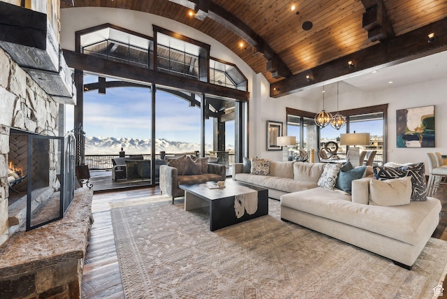 8435 N Ranch Garden Rd, Park City, UT 84098 - living area with wooden ceiling with exposed beams, hardwood / wood-style flooring, a chandelier, a mountain view, and a fireplace