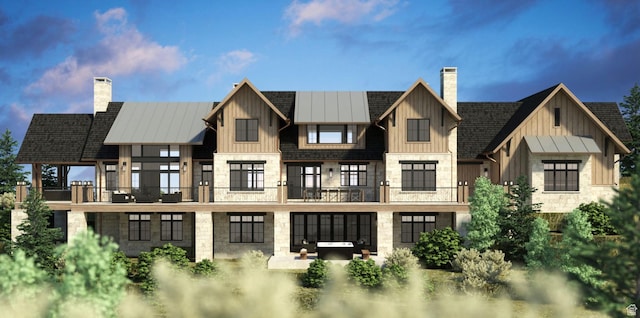 rear view of property featuring a balcony and a patio area