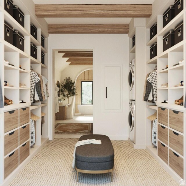 interior space with light carpet and stacked washer / drying machine