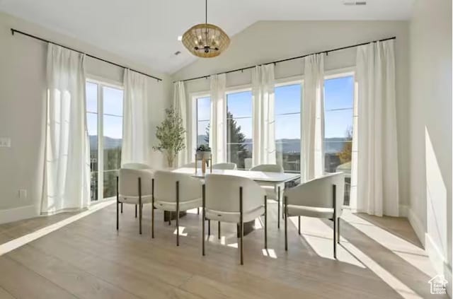 208 W Stone Gate Ln, Provo, UT 84604 - dining space featuring lofted ceiling, wood finished floors, a chandelier, and baseboards