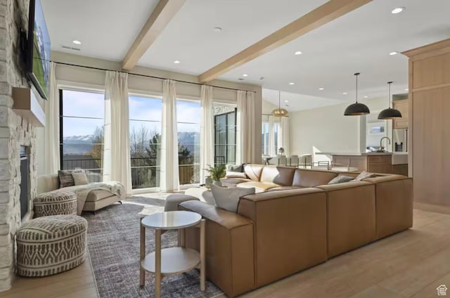 208 W Stone Gate Ln, Provo, UT 84604 - living room featuring beamed ceiling, a fireplace, light wood finished floors, and recessed lighting
