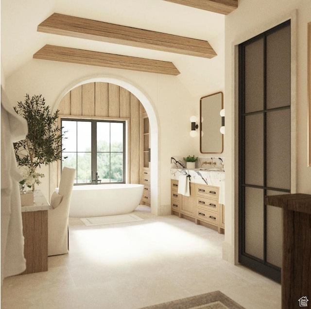 bathroom with vanity, a bathing tub, and lofted ceiling with beams