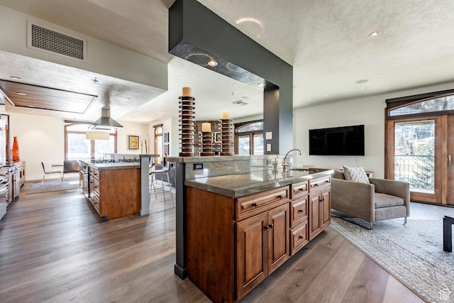751 Main St Unit 415, Park City, UT 84060 - kitchen with dark hardwood / wood-style floors, a center island, sink, and a textured ceiling