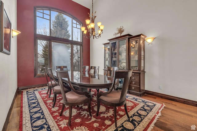 4230 Moosehollow Rd, Park City, UT 84098 - dining space featuring hardwood / wood-style flooring, a chandelier, and a high ceiling