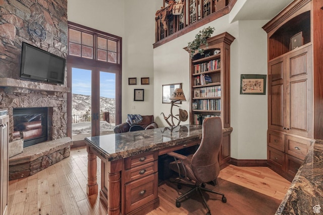 4230 Moosehollow Rd, Park City, UT 84098 - office space featuring a high ceiling, a fireplace, and light hardwood / wood-style flooring