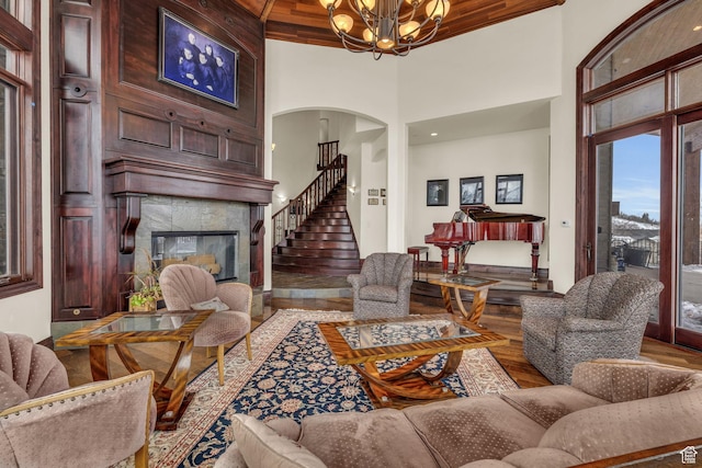 4230 Moosehollow Rd, Park City, UT 84098 - living room with hardwood / wood-style flooring, a large fireplace, a chandelier, and a high ceiling