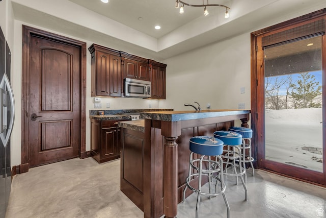 4230 Moosehollow Rd, Park City, UT 84098 - kitchen with a breakfast bar, sink, and dark brown cabinets