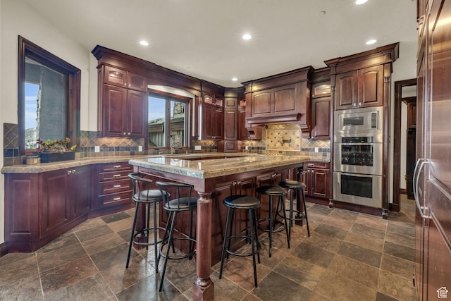4230 Moosehollow Rd, Park City, UT 84098 - kitchen with a kitchen bar, stainless steel appliances, a center island, and decorative backsplash