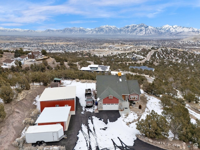 snowy aerial view featuring a mountain view