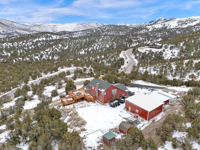 snowy aerial view with a mountain view