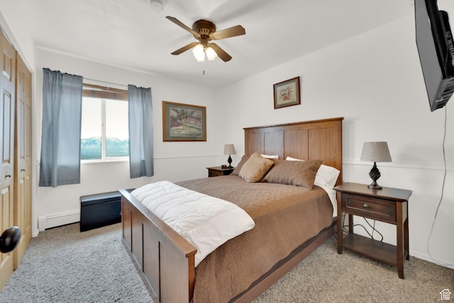 carpeted bedroom featuring ceiling fan and a baseboard radiator