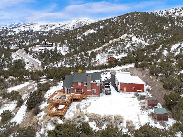 snowy aerial view featuring a mountain view