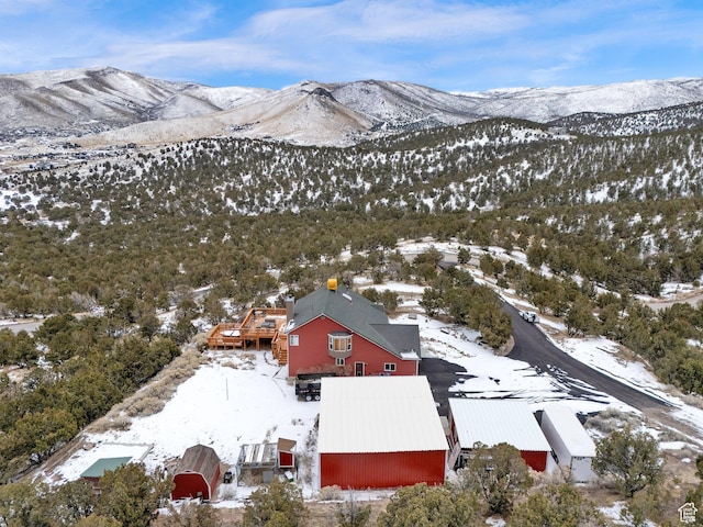snowy aerial view with a mountain view