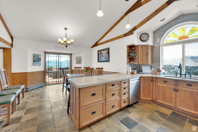 kitchen featuring pendant lighting, sink, a mountain view, stainless steel dishwasher, and kitchen peninsula