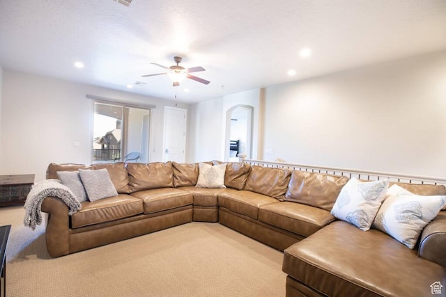 living room featuring light colored carpet and ceiling fan