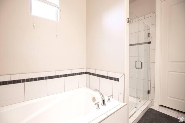 bathroom with tile patterned floors and plus walk in shower