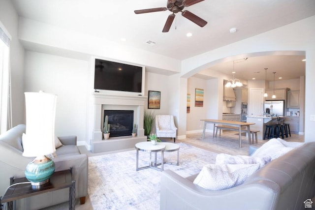 living room with ceiling fan and light wood-type flooring